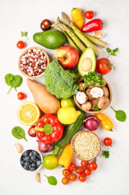 Beyaz arka planda sağlıklı yiyecekler. Taze sebze, meyve, fasulye ve fındık. Kopyalama alanı olan düz.