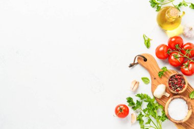 Baharatlar, otlar ve sebzeler ve beyaz mutfak masasında zeytin yağı. Kopyalama alanı olan düz resim.