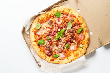 Beyaz arka planda karton kutuda pizza. Jambonlu, salamlı ve sosisli lezzetli et pizzası. Lezzetli öğle veya akşam yemeği, fast food.