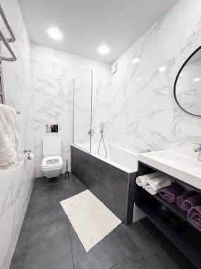 Tuvalette. Lüks banyo, beyaz mermer duvarlar ve gri zemin. Modern iç mimari.
