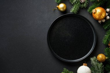 Noel sofrası kurma, yemek geçmişi. Altın Noel süslemeleri ve çatal bıçaklı el işi tabaklar. Kopyalama alanı olan düz.