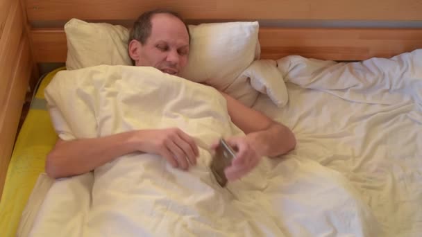 Annoyed Yawning Young Man Receiving Night Call — Stock Video