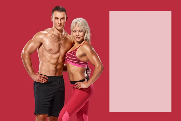 Fit healthy muscular man and woman posing on red background with copyspace for text or advertising