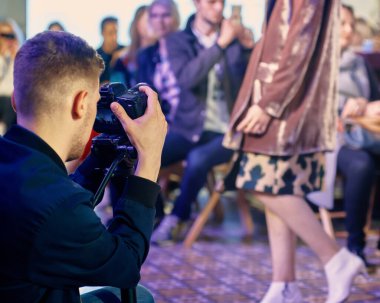 Moda haftasında yeni koleksiyonun tanıtımı için çalışan profesyonel fotoğrafçı.