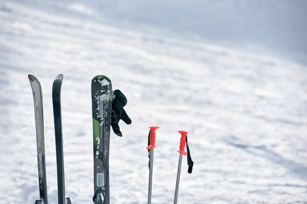 Set of equipment for winter sport on snowy background, closeup photo
