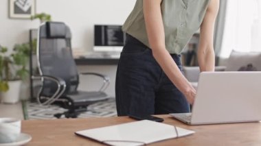 Stab shot of female software developer working with program codes and making phone calls at home office