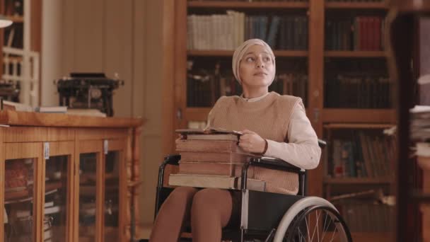 Medium Slowmo Young Muslim Woman Disability Wearing Headscarf Eyeglasses Reading — Vídeos de Stock