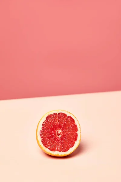 stock image Minimal background image of grapefruit half on pink toned background, copy space