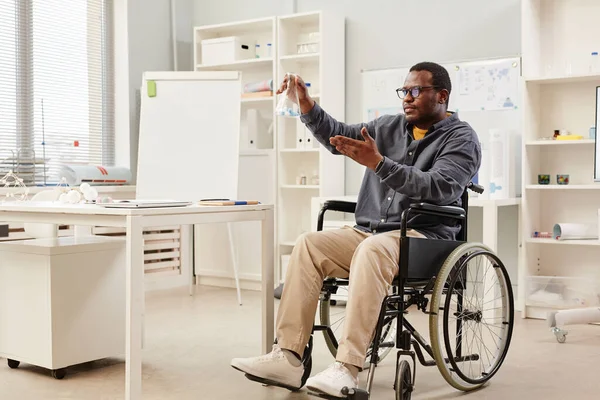 Full Length Portrait African American Teacher Wheelchair Holding Glass Beaker — Stockfoto