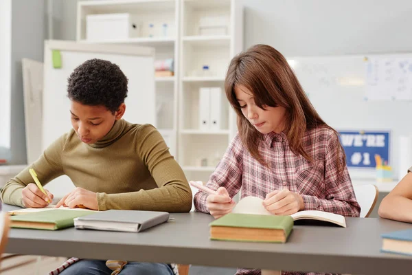 Portrait Two Young Girls Writing Notebooks While Studying School Classroom — Stock Photo, Image