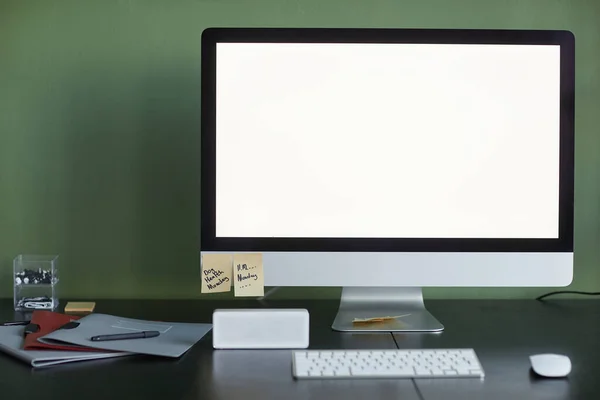 Background image of home office workplace with blank computer screen and smart speaker, copy space