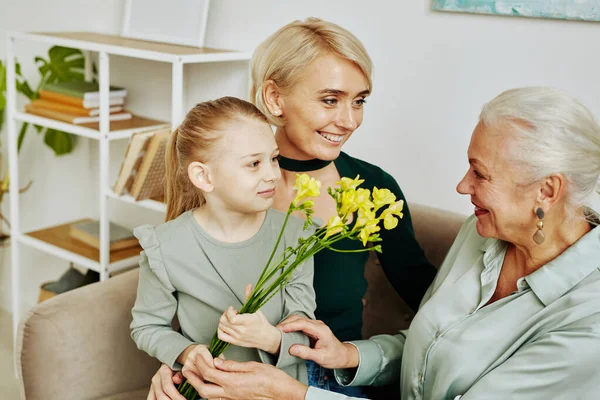 Portrait Little Girl Giving Flowers Grandmother Mothers Day Three Generations — Stock Photo, Image