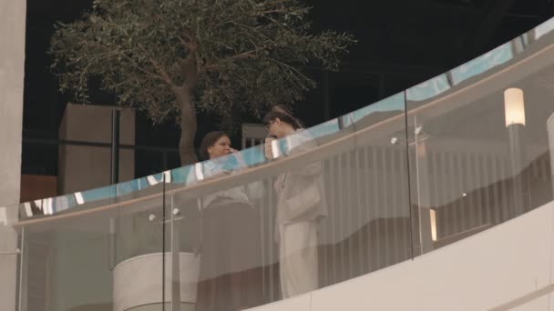 Slowmo Two Young Diverse Businesswomen Standing Glass Railing Second Floor — Stock Video