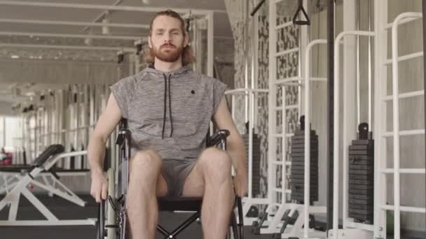 Portrait Young Caucasian Man Sportswear Sitting Wheelchair Looking Camera Rehabilitation — Stock Video