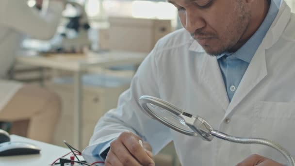 Medium Closeup Slowmo Biracial Male Engineer Cleaning Printed Circuit Board — Stock Video