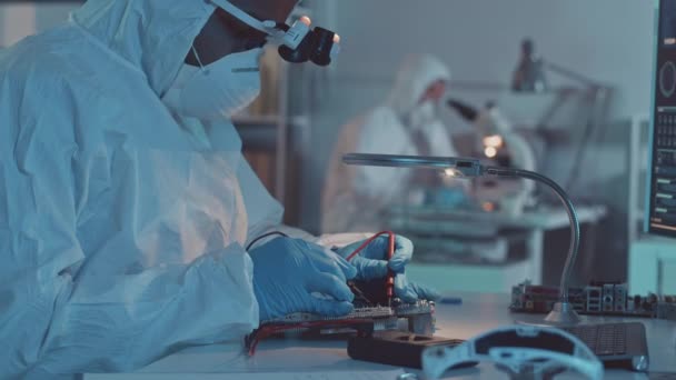 实验室放大镜下男性工程师穿着防护罩和呼吸面罩焊接板的起跳速度 — 图库视频影像