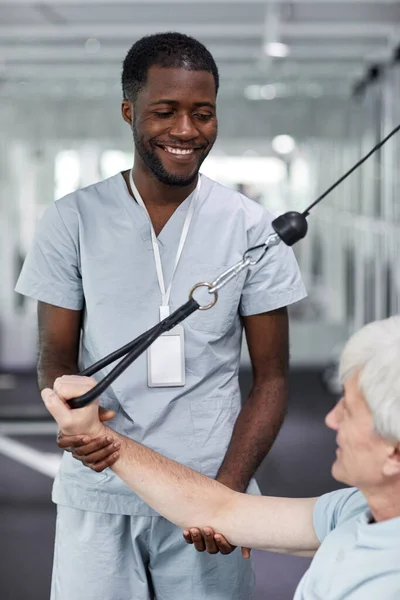 Vertical Portrait Smiling Rehabilitation Therapist Assisting Senior Man Gym Clinic — Stock Photo, Image