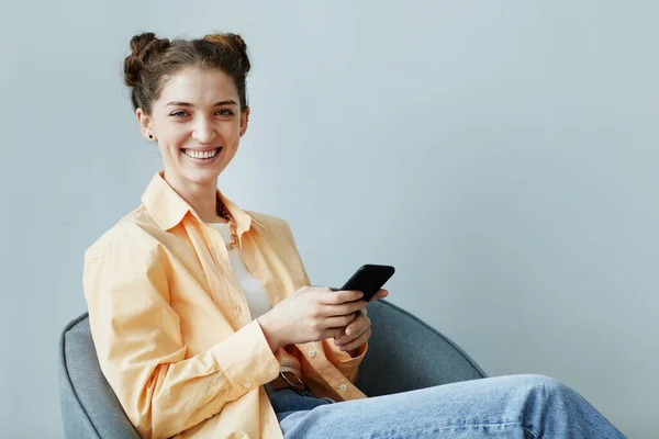 Minimal Portrait Carefree Young Woman Using Smartphone While Sitting Blue — Stock Photo, Image