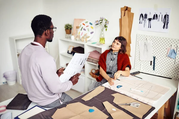 stock image Tailor and fashion designer creating clothes for seasonal collection, discussing sewing patterns and fabric