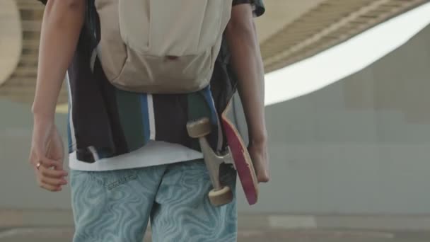 Achteraanzicht Middensectie Slow Van Onherkenbare Jongen Met Skateboard Onder Zijn — Stockvideo