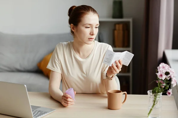 Portrait Caucasian Young Woman Reading Instruction Manual Menstrual Cup Home — Stock Photo, Image
