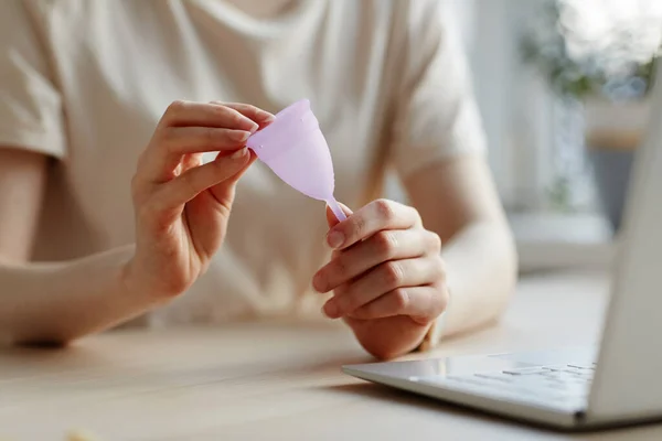 Closeup Young Woman Holding Pink Menstrual Cup Laptop Researching Feminine — Stock Photo, Image
