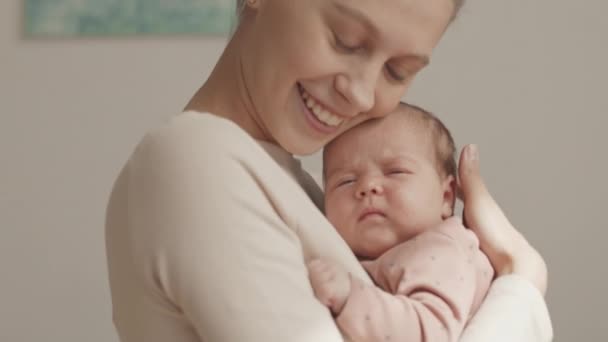 Medium Closeup Slowmo Young Caucasian Woman Smiling Camera Holding Infant — Stockvideo