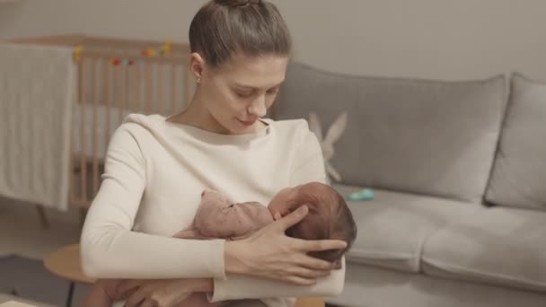Medium Slowmo Happy Young Beautiful Woman Rocking Her Infant Daughter — Vídeos de Stock