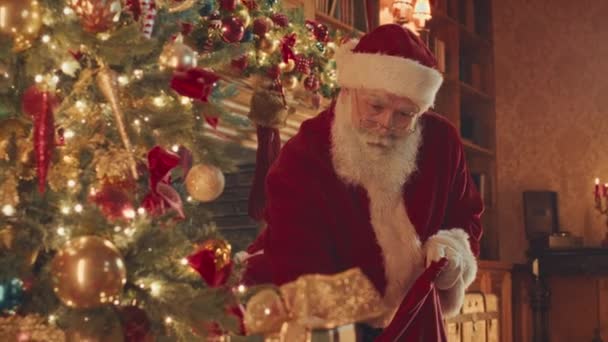 Kind Santa Red Costume Placing Christmas Presents Beautifully Decorated Christmas — Vídeo de Stock