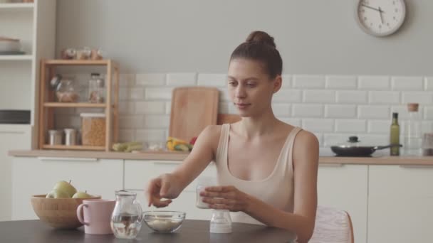 Medium Slowmo Young Caucasian Woman Preparing Baby Milk Formula Kitchen — Video