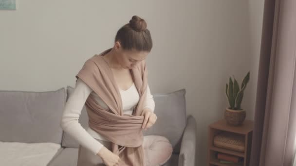 Medium Shot Young Caucasian Woman Wearing Cotton Baby Carrier Home — стокове відео