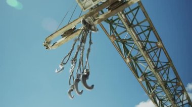 Low angle shot of big construction crane outdoors against clear blue sky