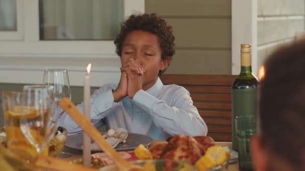 11岁的非洲裔美国男孩在屋外吃家常便饭时闭着眼祈祷 — 图库视频影像
