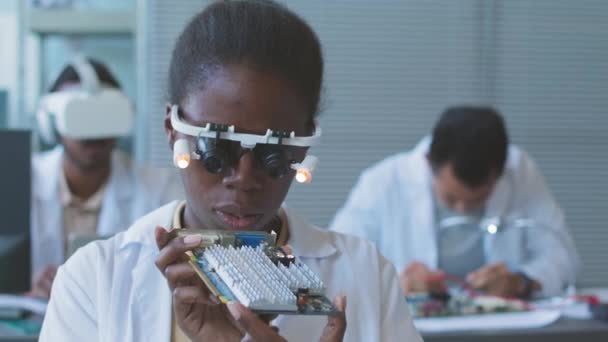Concentrated Young Black Woman Headband Magnifier Examining Motherboard While Working — Stock Video