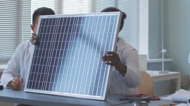 Multiethnic Couple Electronics Engineers Lab Coats Examining Solar Panel While — Video Stock