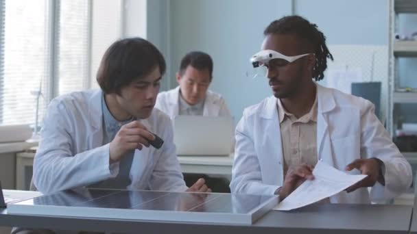 Diverse Male Engineers Looking Technical Drawings While Examining Solar Panel — Stock Video