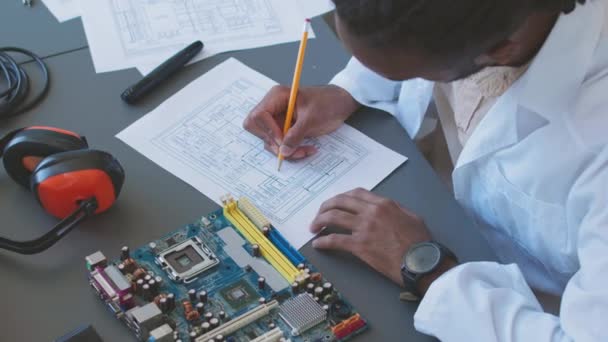 Male Computer Engineer Lab Coat Drawing Scheme Motherboard While Working — Vídeos de Stock
