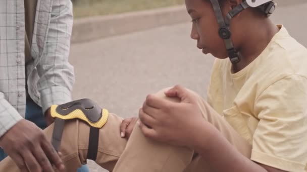 Slowmo African American Father Attaching Knee Pads His Son Legs — Stockvideo