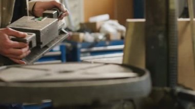 Cropped shot of unrecognizable manufacturer using machinery equipment while working at factory