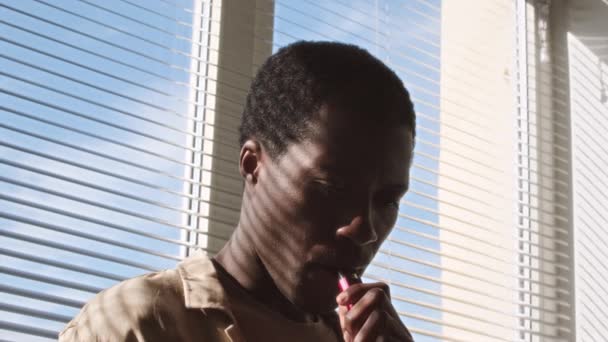 Medium Closeup Slowmo Young Black Man Smoking Electronic Cigarette Window — Vídeo de Stock