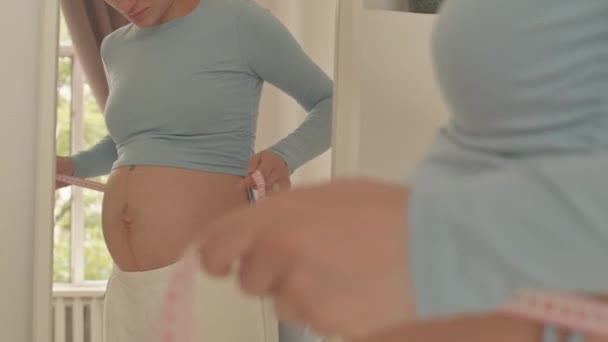 Cropped Shot Young Pregnant Woman Measuring Diameter Her Belly Front — ストック動画