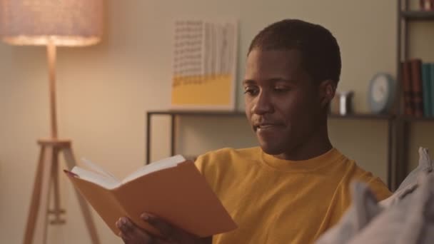 Chest Young Black Man Smoking Electronic Cigarette While Reading Exciting — Video Stock