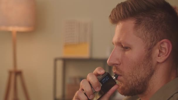 Side View Close Young Caucasian Man Vaping While Reading Home — Stock videók