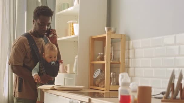 Black Man Baby Son Carrier His Stomach Talking Mobile Phone — Stock Video