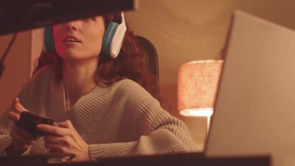 Excited Young Caucasian Woman Wireless Headphones Using Controller While Playing — Stock Video