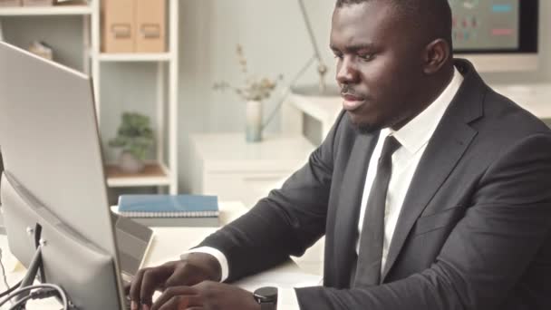 Fokuserad Ung Afroamerikansk Affärsman Elegant Svart Kostym Skriva Trådlöst Tangentbord — Stockvideo