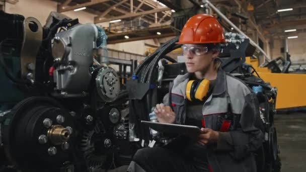 Young Female Engineer Safety Glasses Hard Hat Taking Notes Digital — Stock Video
