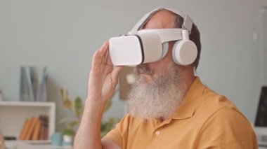 Modern ofiste yazılım mühendisi olarak çalışan yaşlı sakallı adam deneylerde sanal gerçeklik Google 'larını kullanıyor.