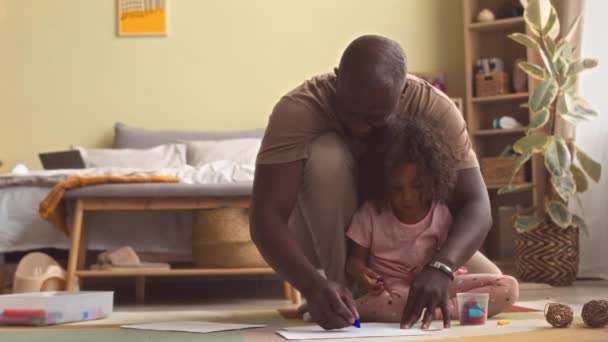 African American Father Little Daughter Drawing Together Crayons Sitting Floor — Stock Video