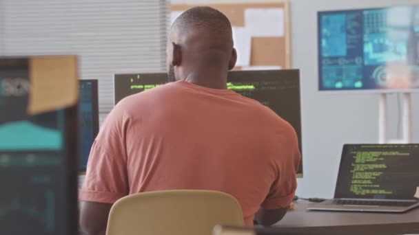사무실에서 새로운 소프트웨어 프로그램에서 컴퓨터와 노트북에 프로그래밍 코드를 아프리카계 프로그래머의 — 비디오